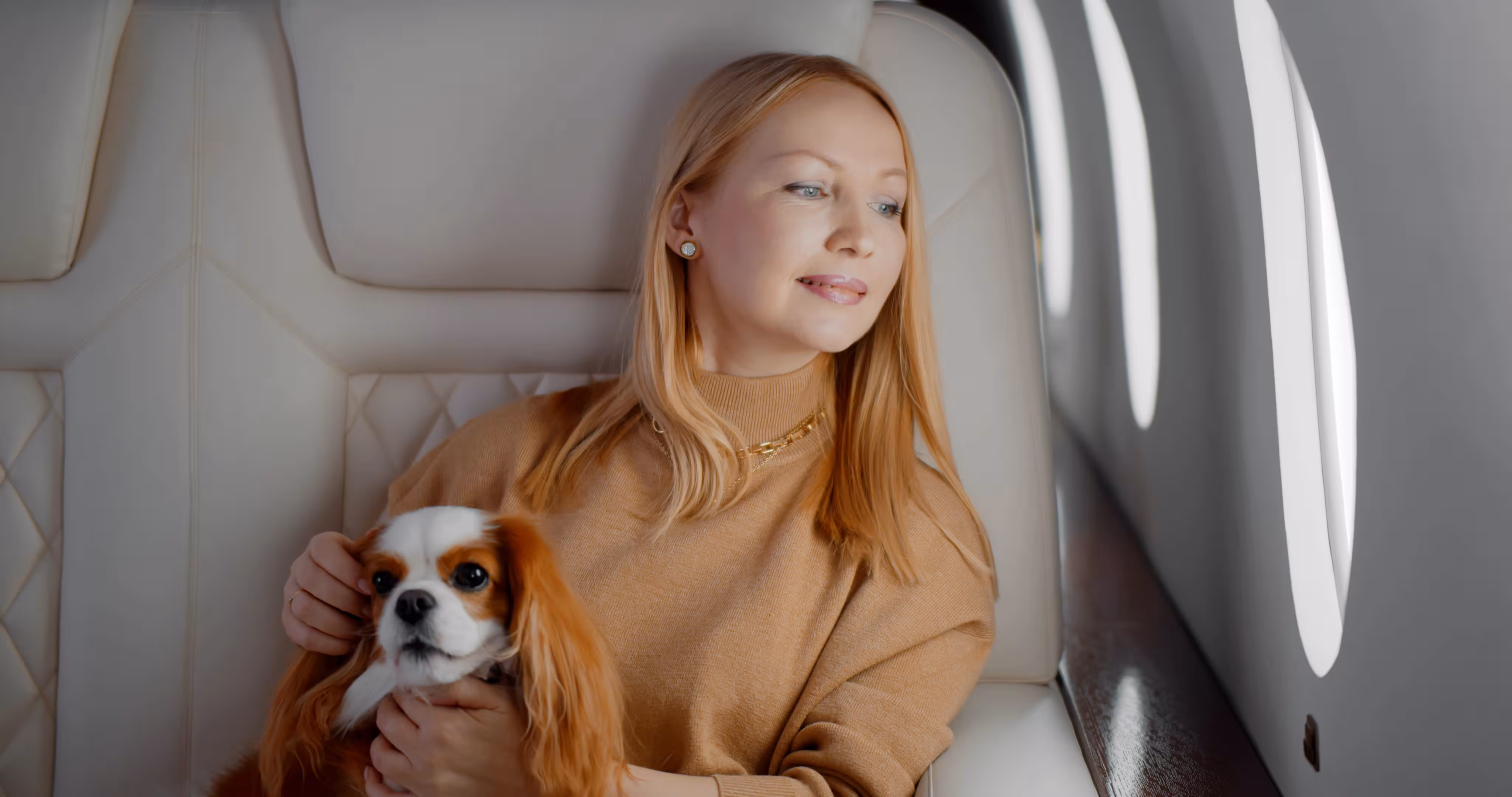 Passenger flying with pet dog on a private jet charter cabin seat